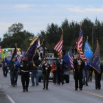 A color guard from Veterans of Foreign Wars Post 10221 in Anchor Point leads the Kenai Peninsula Fair parade Saturday morning in Ninilchik.-Photo by McKibben Jackinsky; Homer News