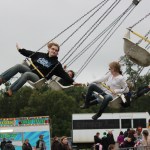 Taylor and Timberlee Davis on Anchor Point fly high on the Swinger at the Kenai Peninsula Fair carnival on Saturday night.-Photo by McKibben Jackinsky; Homer News
