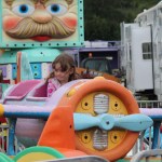 Nevaeh Rawls of Anchor Point flies high at the Kenai Peninsula Fair carnival on Saturday night.-Photo by McKibben Jackinsky; Homer News