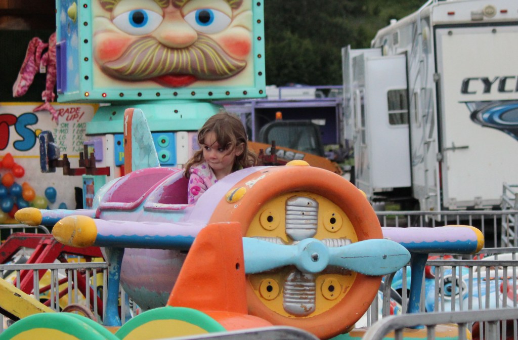 Nevaeh Rawls of Anchor Point flies high at the Kenai Peninsula Fair carnival on Saturday night.-Photo by McKibben Jackinsky; Homer News