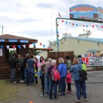 In spite of Saturday morning's rain, visitors lined up at the gate of the Kenai Peninsula Fair. -Photo by McKibben Jackinsky