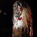 Brandy McGee models “Voodoo Doll” by Keren Lowell. The ensemble was one of several playful works in the show, including Marie Walker’s eerie “Val Zonia Back from Zombie Land.” Lowell had a 19th century-style outfit, “Work Dress,” made entirely of paper. -Photo by Michael Armstrong, Homer News