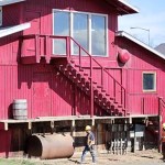 Contractors work on Alice's Champagne Palace last April. Repairs were made to the bar, including tearing out an old back porch and fixing drainage around the basement.-Photo by Michael Armstrong, Homer News