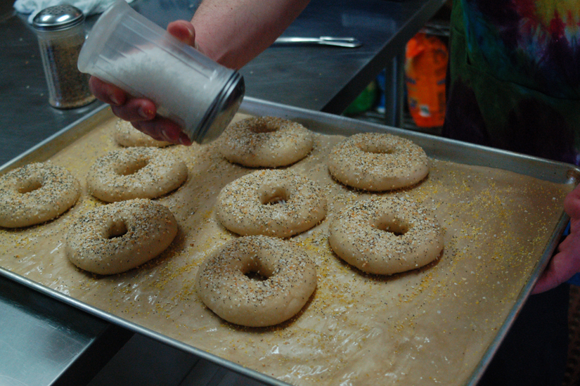 After the bagels have boiled for a few minutes, Chapin brushes them with egg whites, which give bagels that glossy coating.