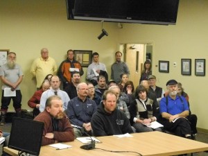 Todd Hoppe, left, a board member of the North Pacific Fisheries Association, speaks in support of a resoultion urging the Board of Fish to reject proposals that would restrict the drift fleet. Matt Alward, right, owner of Bulletproof Nets, waits his turn to speak.                               -Photo by Michael Armstrong, Homer News