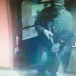 This enlarged version of a photo taken by security cameras at the Grog Shop shows the robber entering the store on Dec. 26 carrying what appears to be a Snakecharmer .410-caliber shotgun.-Photo provided, Homer Police Department