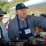 Deputy Commissioner of the Alaska Dept. of Transportation and Public Facilities Reuben Yost, left, and Lt. Gov. Mead Treadwell, right, serve food at the Governor’s Family Picnic.-Photo by Michael Armstrong, Homer News