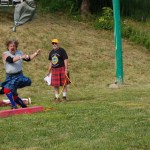 Dave Rasmessen of Anchorage throws the halibut as Robert Archibald watches.-Photo by Michael Armstrong, Homer News