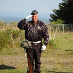 Eric Henley of the Anchor Point Veterans of Foreign Wars Auxiliary salutes a rifle and helmet symbolizing America’s war dead during Memorial Day ceremonies at Hickerson Memorial Cemetery.-Photo by Michael Armstrong, Homer News