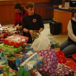 Emerson Coppo carries a gift from the Share the Spirit gift tree at Wells Fargo-Photos by Michael Armstrong and McKibben Jackinsky, Homer News; and Derotha Ferraro