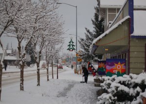 Sam Young shovels the sidewalk in front of Fireweed Gallery and Ptarmigan Arts on Monday afternoon. The weekend outlook calls for more snow on Christmas and sunshine on Friday.-Photo by Michael Armstrong, Homer News