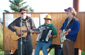 From left to right, Ray Troll, John “Johnny B.” Bushell and David Montgomery play at the Cook Inletkeeper Splash Bash July 31 at Bishop’s Beach. Troll of Ketchikan and Bushell of Homer play with the Ratfish Wranglers, and Montgomery of Seattle plays with Big Dirt. Both bands played at Salmonstock last weekend. Montgomery, author of “King of Fish,” also spoke at the Splash Bash and Salmonstock.-Photo by Michael Armstrong, Homer News