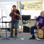 Betsy Scott sings while Eddie Wood plays the cajon at the Homer Council on the Arts Street Faire last Saturday.-Photo by Michael Armstrong, Homer News