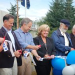 Dignitaries cut the ribbon at the natural gas valve-turning ceremony on Thursday. From left to right are Homer Chamber of Commerce President Pat Melone, Sen. Peter Micciche, R-Soldotna, Gov. Sean Parnell, Enstar Natural Gas President Colleen Starring, Rep. Paul Seaton, R-Homer, South Peninsula Hospital CEO Bob Letson, and Homer Mayor Beth Wythe.-Photo by Michael Armstrong, Homer News