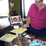 Anna Wall of Red Bird Sweets puts a finishing touch on rosewater and cream cheese-filled pizelles.-Photo by McKibben Jackinsky, Homer News