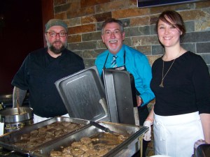 Land’s End Resort-Chart Room Restaurant’s executive chef Billy Roberson, director of hospitality Darrel Oliver and, from the resort’s human resource office, Christina Fenner offer melt-in-your-mouth servings of elk meatloaf atop a potato pancake.-Photo by McKibben Jackinsky, Homer News