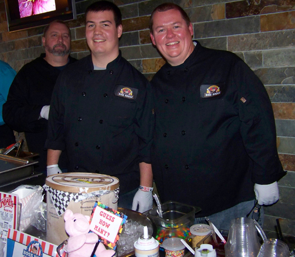 Boss Hoggz crew Rich Jamieson, Garet Moyer and restaurant owner Jimmy Lower, serve sundaes at the Saturday night event.-Photo by McKibben Jackinsky, Homer News