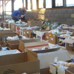 Volunteers help organize more than 200 boxes of food.-Homer News file photo
