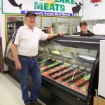 Sure Santa’s nice to visit with at Ninilchik Trading’s grand opening, but it’s the cookie that has Victoria Franey’s attention.-Photo by McKIbben Jackinsky, Homer News