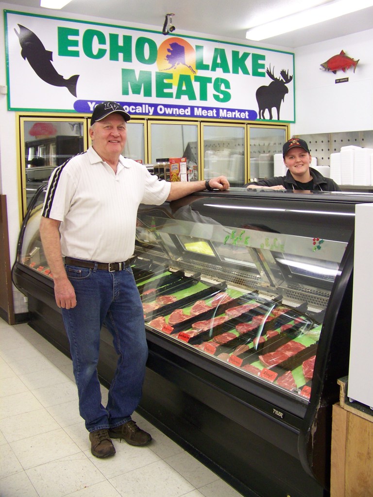 Sure Santa’s nice to visit with at Ninilchik Trading’s grand opening, but it’s the cookie that has Victoria Franey’s attention.-Photo by McKIbben Jackinsky, Homer News
