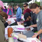 Catriona Lowe, right, of Kachemak Bay Family Planning Clinic, signs up participants in Sunday's Breast Cancer Run.-Photo by McKibben Jackinsky,  Homer News