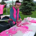 Clare Wheeler, a clinic assistant at Kachemak Bay Family Planning Clinic, ensures everyone at Sunday's Breast Cancer Run has something to wear that's pink, the color associated with breast cancer awareness. -Photo by McKibben Jackinsky,  Homer News