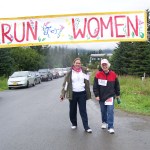 Breast cancer survivors Mary Johnson and Connie Prouty cross the finish line after completing the one-mile walk of Sunday's Breast Cancer Run.-Photo by McKibben Jackinsky,  Homer News