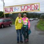 Jackie McDonough and Carmen Field cross the finish line of the Breast Cancer Run's one-mile walk on Sunday morning.-Photo by McKibben Jackinsky,  Homer News