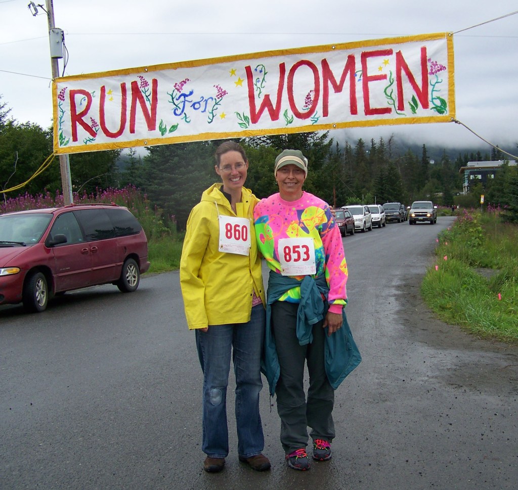 Jackie McDonough and Carmen Field cross the finish line of the Breast Cancer Run's one-mile walk on Sunday morning.-Photo by McKibben Jackinsky,  Homer News