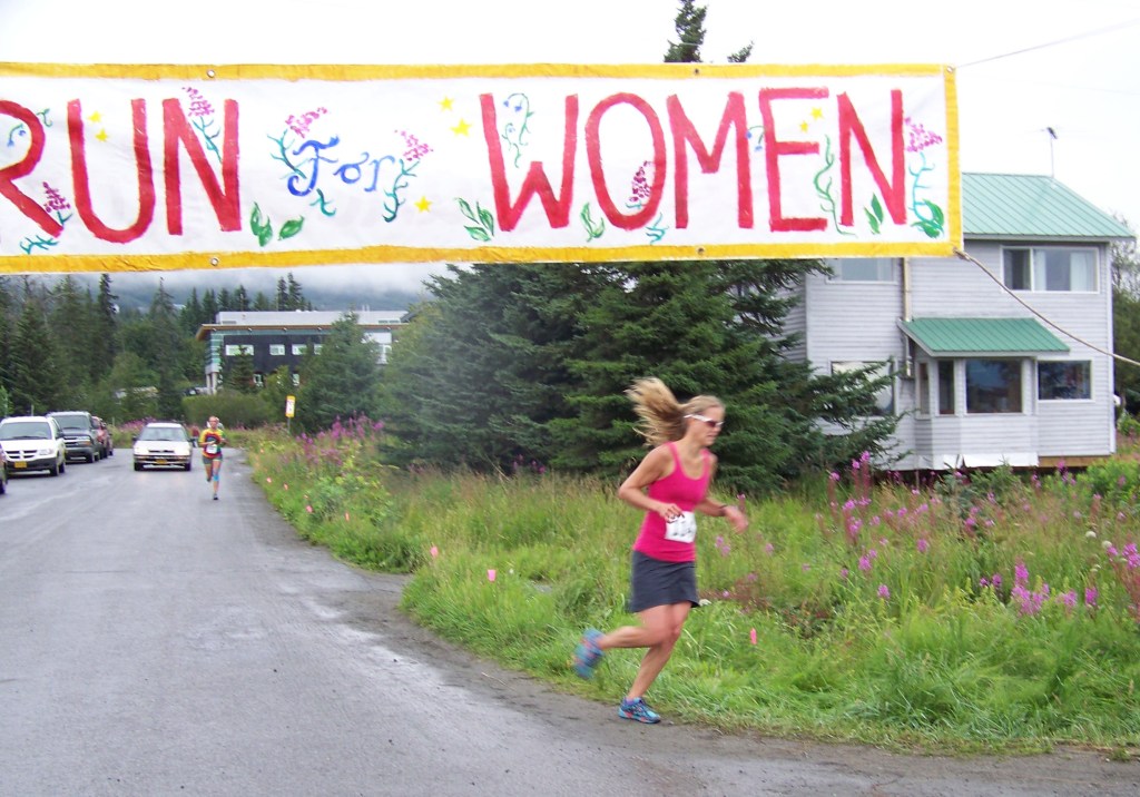 Mary Kate Green is the first woman across the finish line of Sunday's Breast Cancer Run, with a time of 37:41:00. She was followed closely by Hanna Johnson, with a time of 37:48:00.-Photo by McKibben Jackinsky,  Homer News