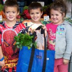 Shead, Trace and Arrienna Fleenor load up on fresh veggies at Saturday’s Homer Farmers’ Market.-Photo by McKibben Jackinsky, Homer News