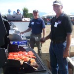 Homer Harbormaster Bryan Hawkins and Homer City Council member Bryan Zak grill food at the picnic.-Photo by McKibben Jackinsky, Homer News