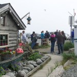 Linda Rowell, in the pink shirt, prepares to lead a Pratt Museum historic harbor walking tour.-Photos by McKibben Jackinsky, Homer News
