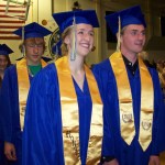 Homer High School graduates, from left, Katie Pitzman, Ethan Kizzia, Katie Kirsis and Grant Arseneau march into the gym at the school’s commencement ceremony Sunday evening.-Photo by McKIbben Jackinsky, Homer News