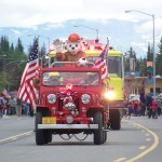 Mark Marette entertains parade crowds with some tall tales and words of wisdom.-Photo by McKibben Jackinsky, Homer News