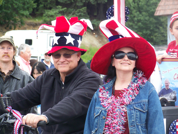 High School Rodeo Queen Kylie Iverson of Palmer carries the flag at Ninilchik’s rodeo-Photo by McKibben Jackinsky, Homer News