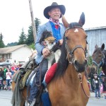 Alex and Adrienne Sweeney, owners of the Driftwood Inn in Homer’s Old Town, give a red-white-and-blue nod to the past and present in the July Fourth parade. -Photo by McKibben Jackinsky, Homer News