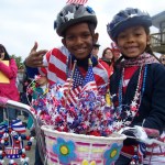 Eager teams of rain-gear wearing youngsters compete in a slip-and-slide relay.-Photo by McKibben Jackinsky, Homer News
