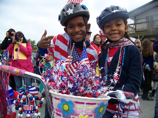 Eager teams of rain-gear wearing youngsters compete in a slip-and-slide relay.-Photo by McKibben Jackinsky, Homer News