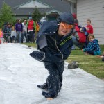 A member of a survival suit relay team puts a well-timed bounce to her advantage.-Photo by McKibben Jackinsky, Homer News