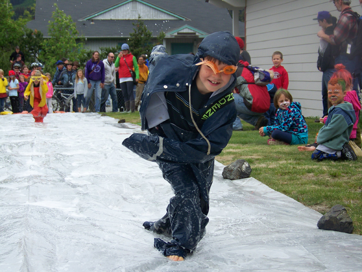 A member of a survival suit relay team puts a well-timed bounce to her advantage.-Photo by McKibben Jackinsky, Homer News