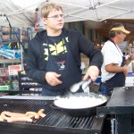 Bernard Villa and his dad, Alex, serve a hot meal on a rainy Kenai Peninsula Fair afternoon.-Photo by McKibben Jackinsky, Homer News