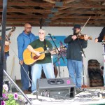 Kenail Peninsula Fair board president Marti Krohn takes center stage with the Dirty River Ramblers, whose musicians include Mace Hathaway; Cris Hunke; her son, Josh; and Jostin Kephart. -Photo by McKibben Jackinsky, Homer News
