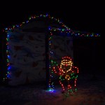 Santa stands guard outside a building where food is served during the fair.