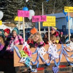 Kachemak Nordic Ski Club members wave from a float.-Photo by McKibben Jackinsky, Homer News