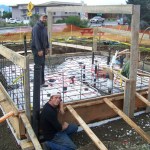 Paul Ridgely and Nate Ellington of Eayrs Plumbing and Heating work on the restroom being constructed at the WKFL Park.  -Photo by McKibben Jackinsky, Homer News