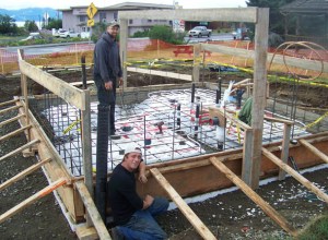 Paul Ridgely and Nate Ellington of Eayrs Plumbing and Heating work on the restroom being constructed at the WKFL Park.  -Photo by McKibben Jackinsky, Homer News