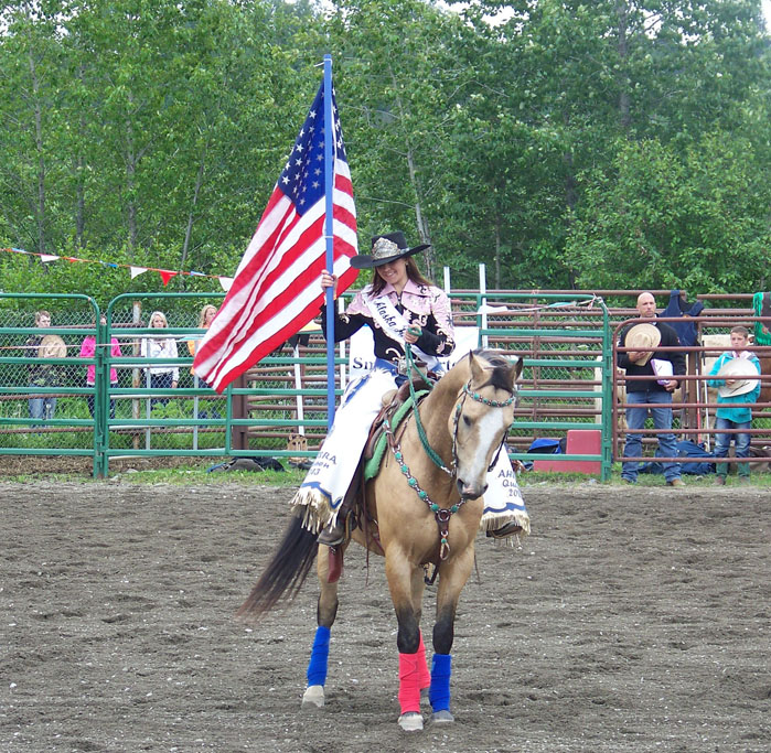 A patriotic bicyclist rides down Seldovia’s main street-Photo by McKibben Jackinsky, Homer News