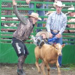 Ninilchik rodeo family camaraderie is evident in each event, whether it’s a young cowboy experiencing the thrill of calf riding, a bull rider trying to hang on for eight seconds, or the two-member teams in the roping competitions.-Photo by McKibben Jackinsky, Homer News