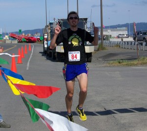 Jake Moe of Anchorage is the first one ot cross the finish line of the 2013 10K Run for the Bay Spit Run today, with a time of 32:40.-McKibben Jackinsky